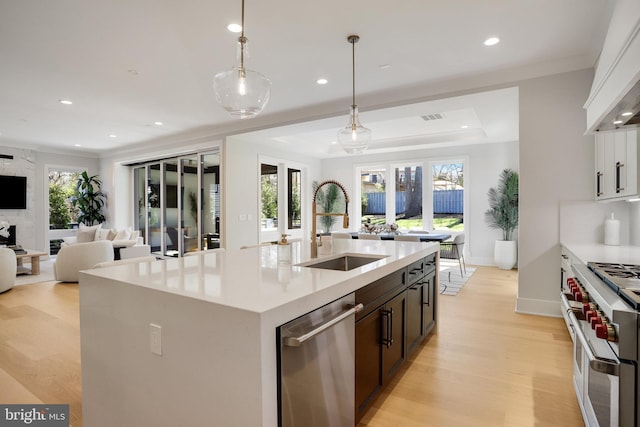 7013 Raleigh Rd, Annandale, VA 22003 - kitchen with stainless steel dishwasher, a sink, light wood-type flooring, double oven range, and open floor plan