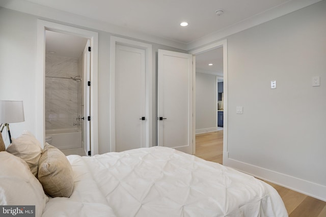 7013 Raleigh Rd, Annandale, VA 22003 - bedroom with light wood finished floors, ensuite bathroom, baseboards, and recessed lighting