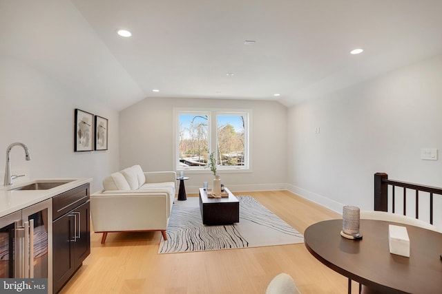 7013 Raleigh Rd, Annandale, VA 22003 - sitting room with recessed lighting, light wood-style floors, vaulted ceiling, and baseboards