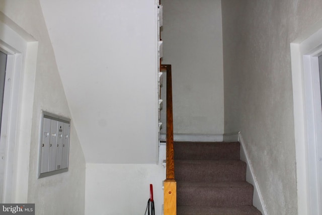 stairway featuring a mail area