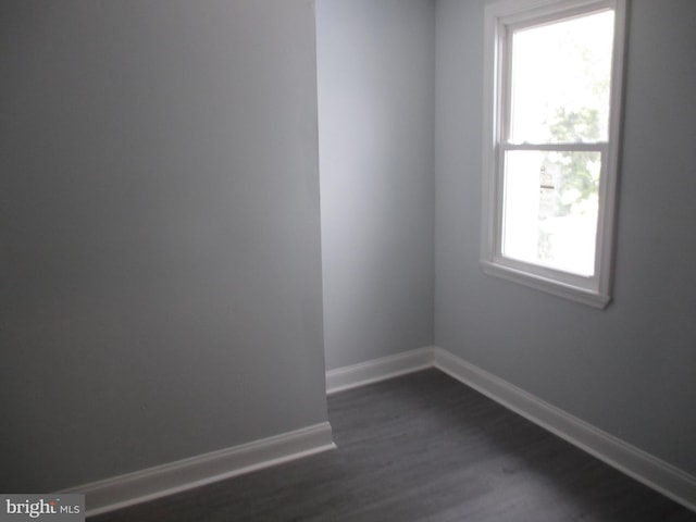 unfurnished room featuring dark hardwood / wood-style flooring