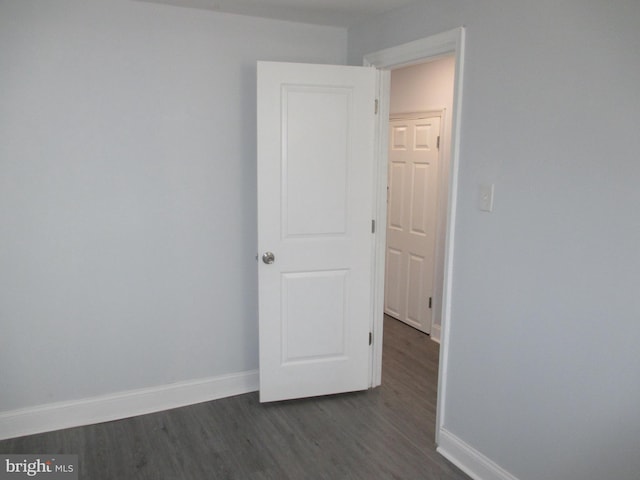 unfurnished room featuring dark hardwood / wood-style flooring