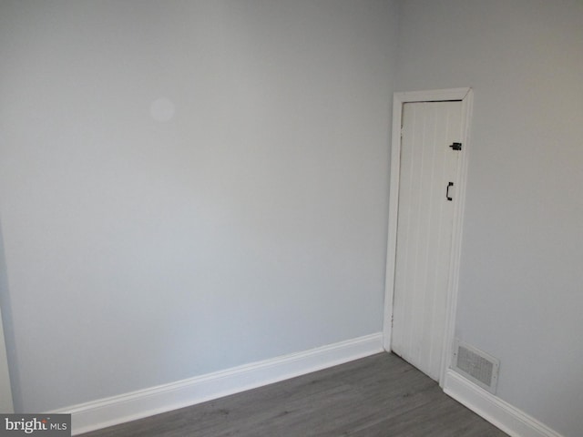 unfurnished room featuring dark wood-type flooring