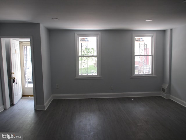 spare room with dark hardwood / wood-style flooring