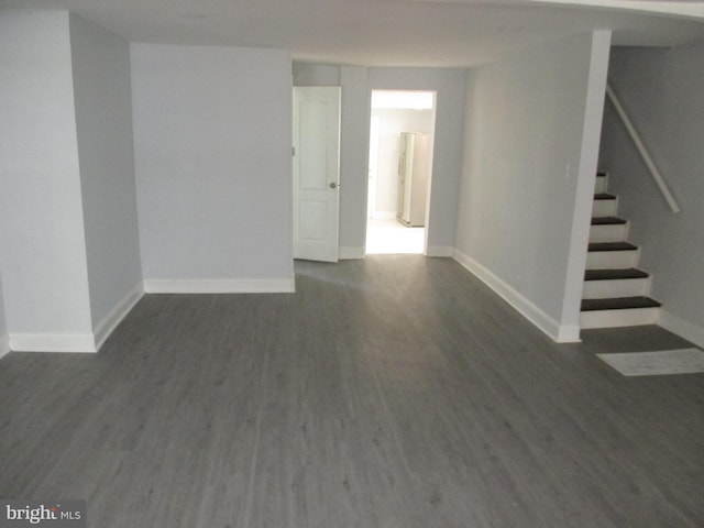 unfurnished room with dark wood-type flooring