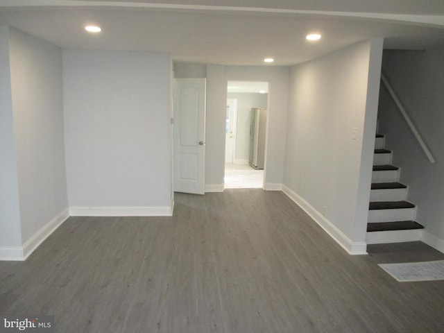 basement featuring dark hardwood / wood-style flooring