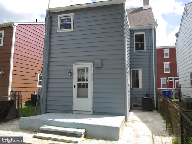 rear view of house with central air condition unit