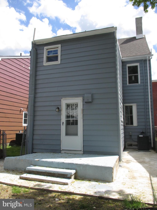 rear view of property with cooling unit