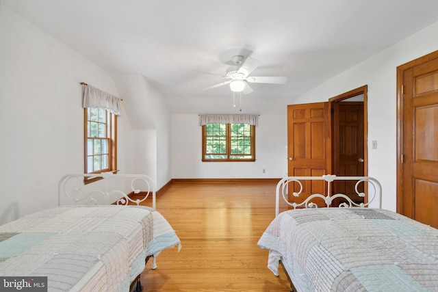 bedroom featuring multiple windows, ceiling fan, and light wood-type flooring