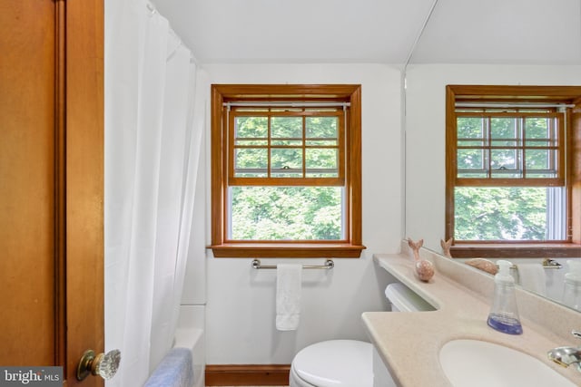 full bathroom with vanity, toilet, and shower / tub combo with curtain