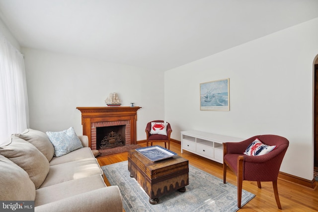 living room featuring hardwood / wood-style flooring and a fireplace