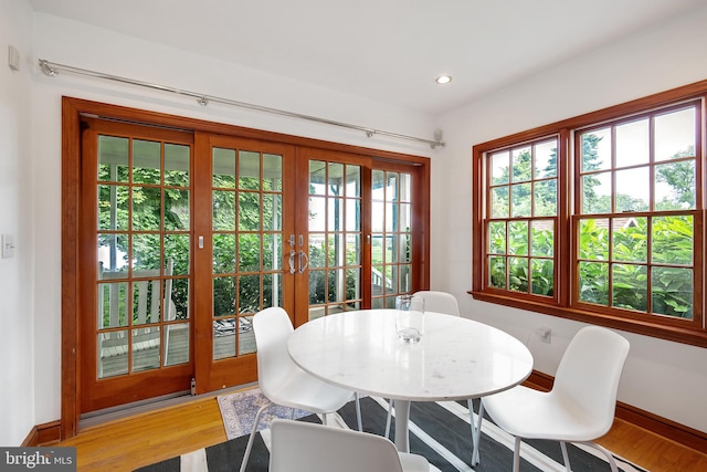 dining space featuring french doors and hardwood / wood-style flooring