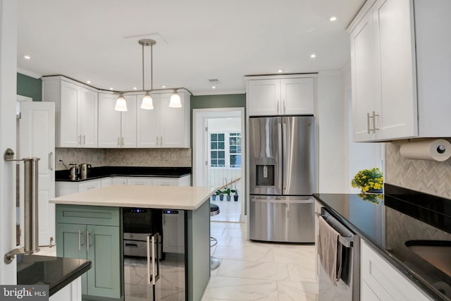 kitchen featuring white cabinets, pendant lighting, stainless steel appliances, and decorative backsplash