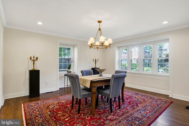 dining space with crown molding, a chandelier, and dark hardwood / wood-style floors