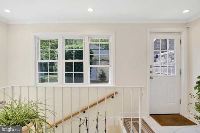 entryway featuring crown molding