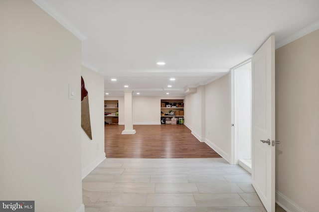 hallway with light hardwood / wood-style flooring and ornamental molding