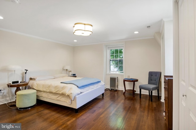 bedroom with dark hardwood / wood-style flooring, radiator heating unit, and ornamental molding