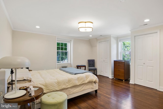 bedroom featuring crown molding and dark hardwood / wood-style floors