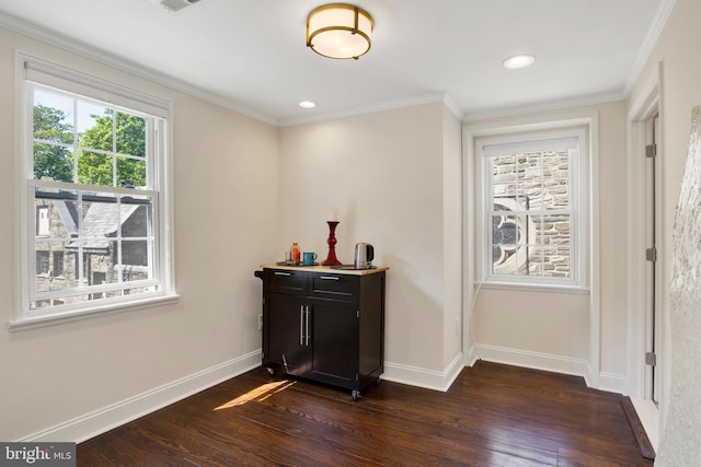 foyer with dark wood-type flooring and ornamental molding