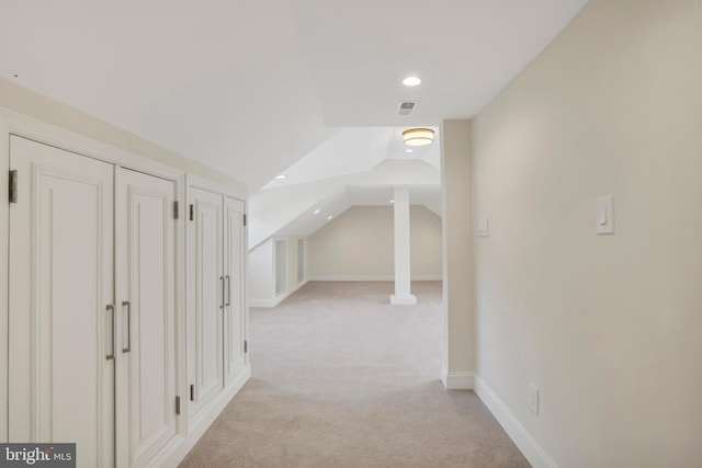 additional living space featuring light carpet and vaulted ceiling