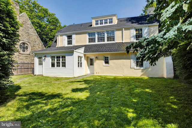 rear view of house with a lawn