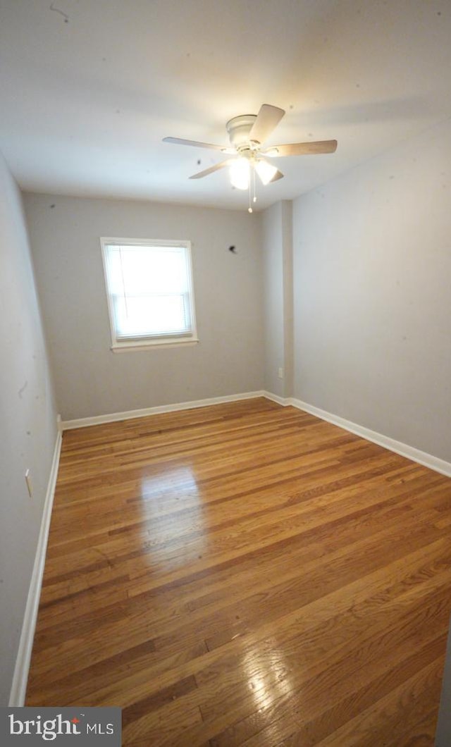 spare room featuring hardwood / wood-style flooring and ceiling fan