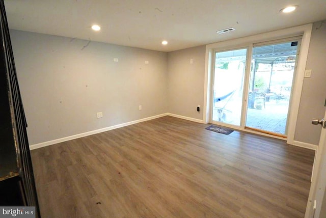 unfurnished room with dark hardwood / wood-style flooring