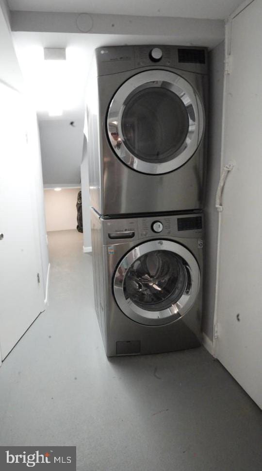 laundry room with stacked washer and clothes dryer