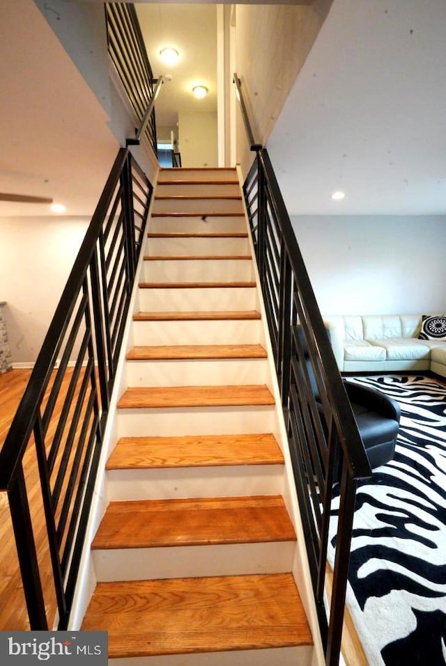 stairway featuring hardwood / wood-style flooring