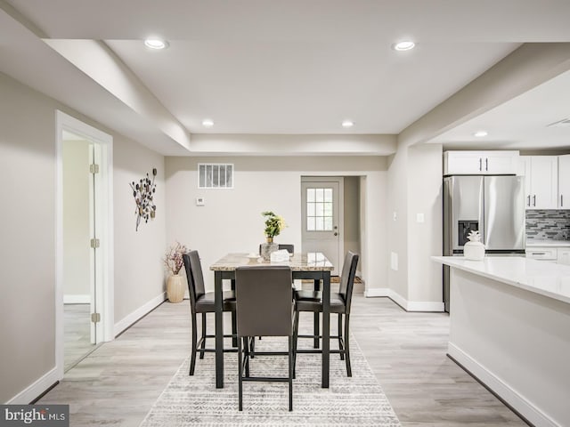 dining area featuring light wood-type flooring