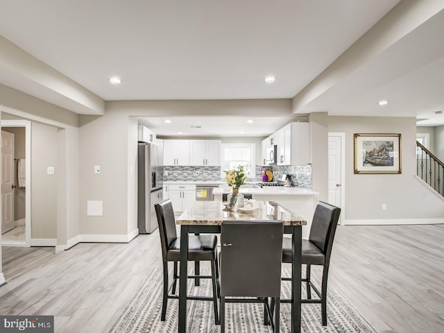 dining space featuring light wood-type flooring