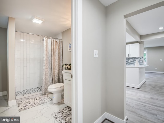 bathroom with walk in shower, vanity, decorative backsplash, and toilet