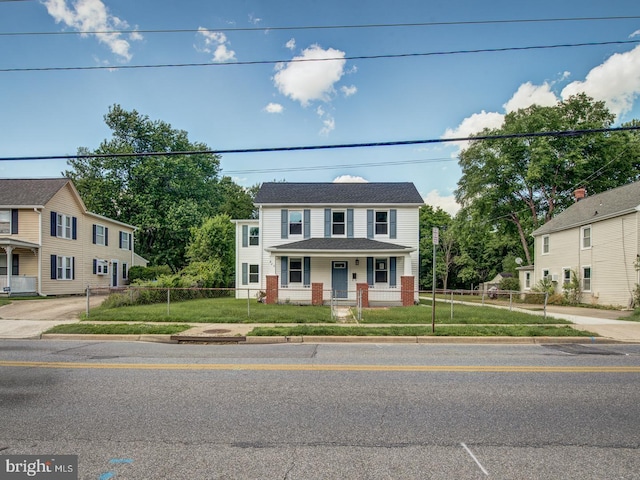 view of front of home with a porch and a front yard