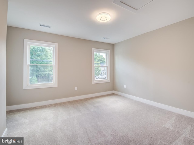 unfurnished room with light colored carpet