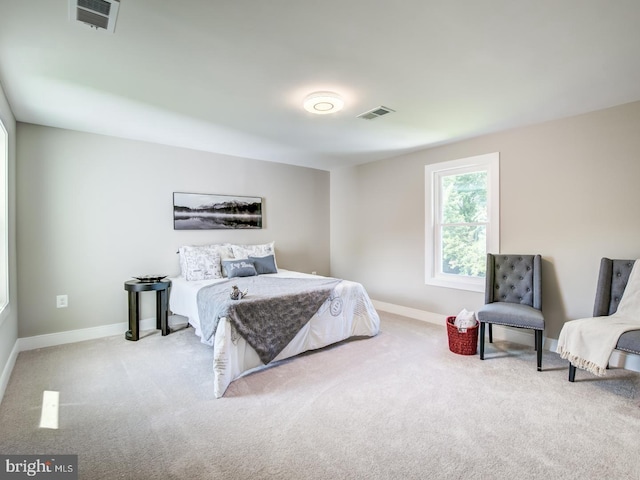 bedroom featuring light carpet