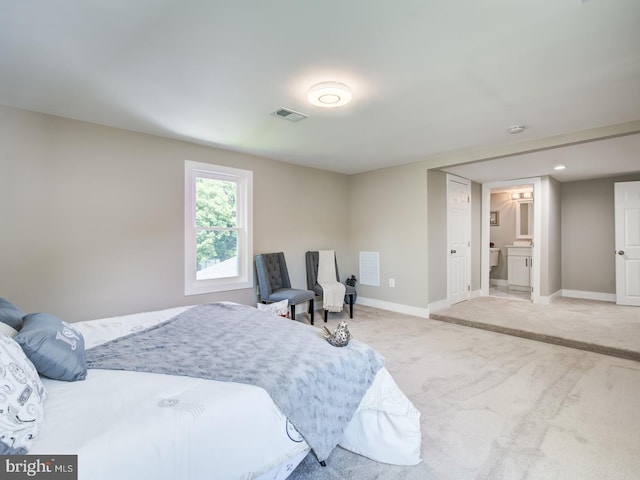 carpeted bedroom with connected bathroom