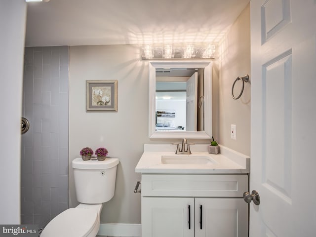 bathroom featuring toilet and vanity