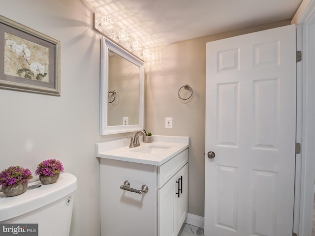 bathroom featuring toilet and vanity