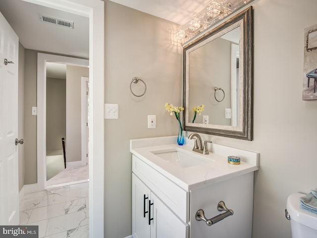 bathroom featuring toilet and vanity