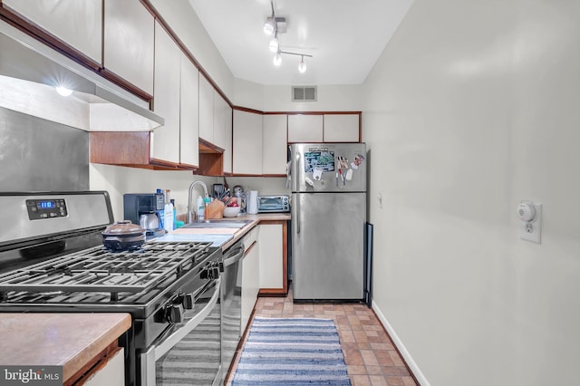 kitchen featuring sink, white cabinets, and stainless steel appliances