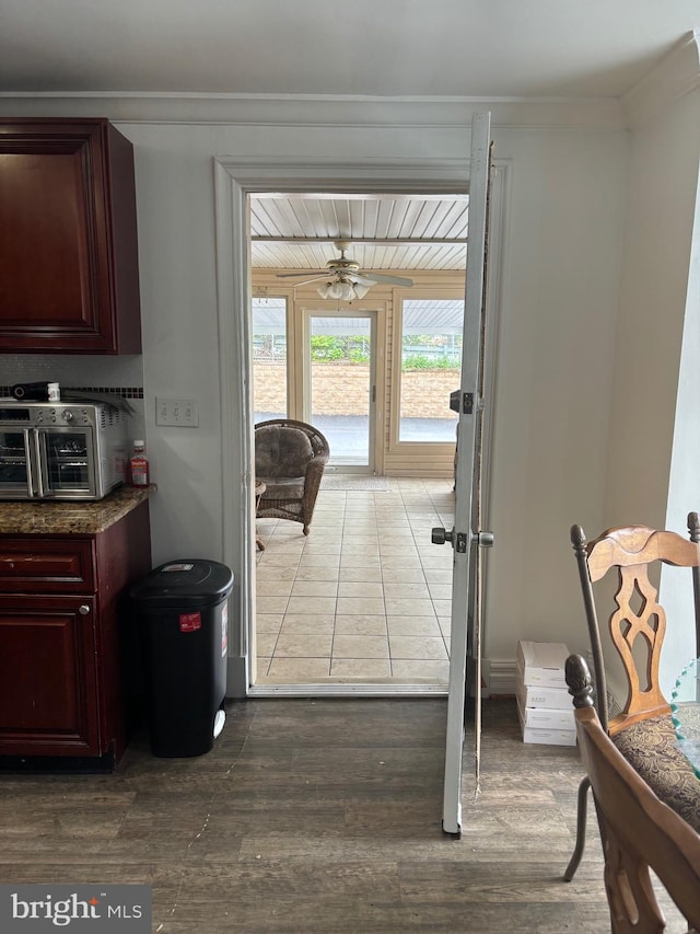 doorway to outside featuring hardwood / wood-style floors, ceiling fan, and ornamental molding