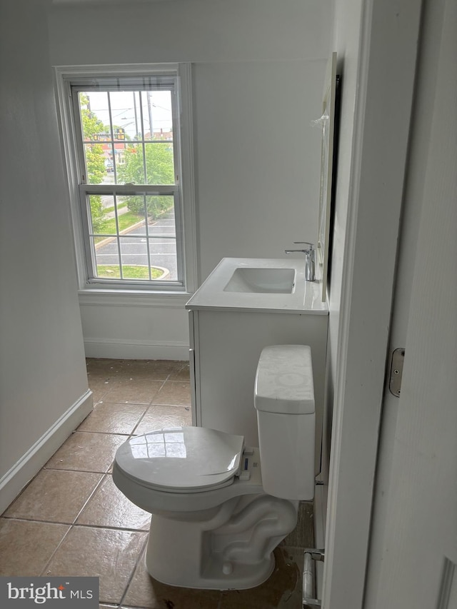 bathroom featuring tile patterned floors, vanity, and toilet