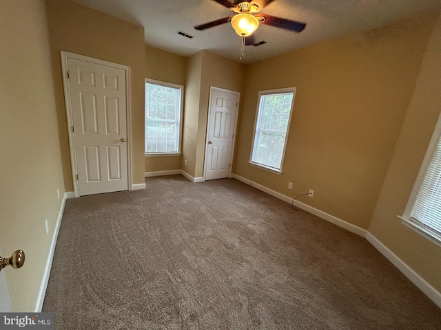 unfurnished bedroom featuring carpet and ceiling fan