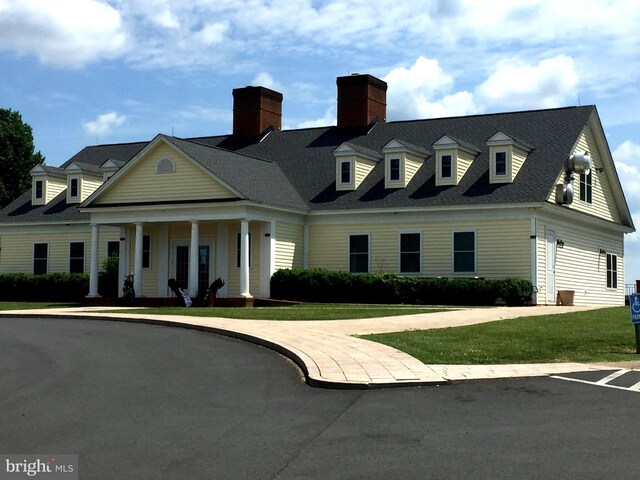 new england style home featuring a front lawn