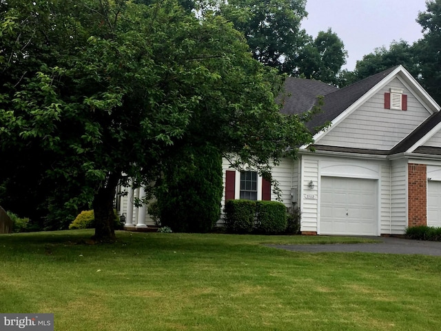 view of front facade with a front yard and a garage