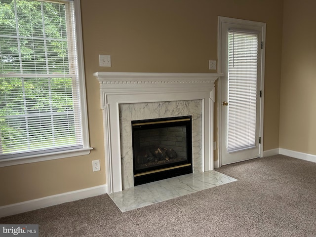 room details featuring carpet flooring and a fireplace