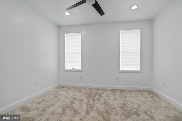 unfurnished room with ceiling fan and light colored carpet