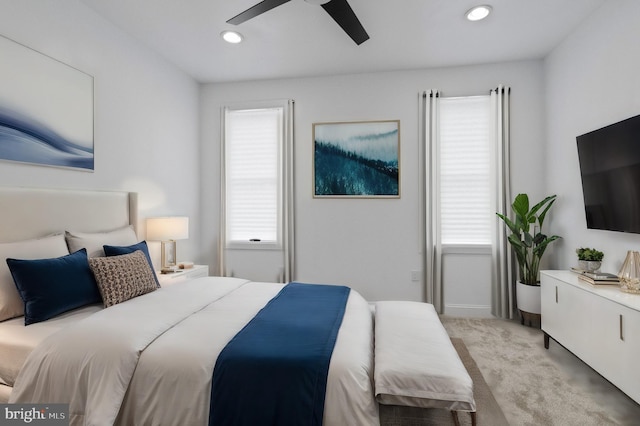 bedroom with ceiling fan and light colored carpet