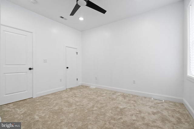 spare room featuring ceiling fan and carpet floors