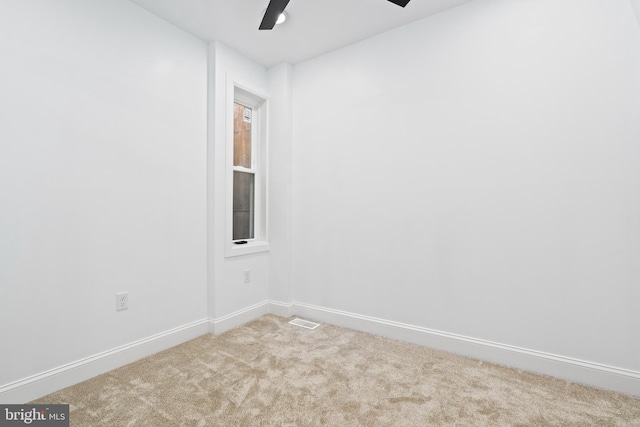 unfurnished room with ceiling fan and light colored carpet